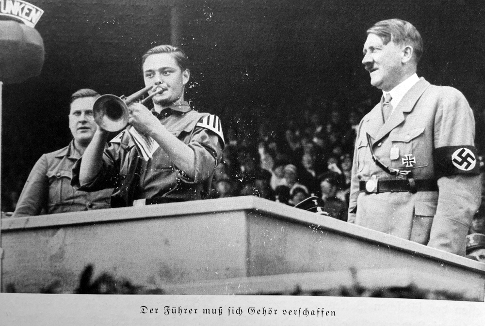 A trumpet call is announcing the speech of the Führer at the rally of the Hitler Youth in Nuremberg's stadium